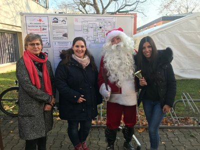 Group picture with three women and a Santa Claus.